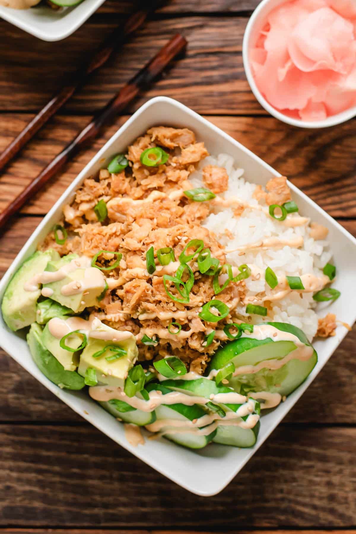 Tuna sushi bowl with rice and veggies, drizzled with sriracha mayo.