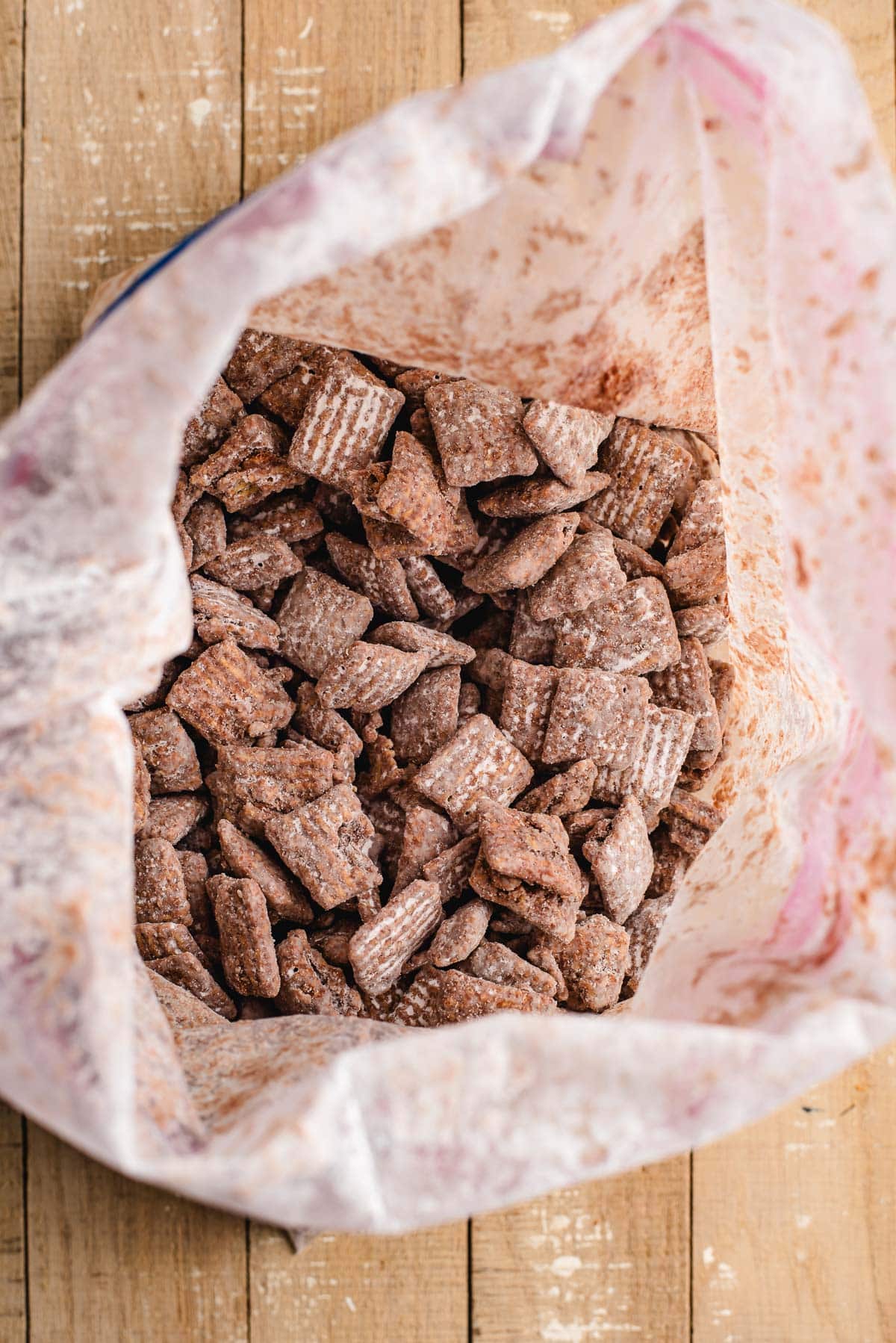 Chocolate peanut butter chex in a zip lock bag, with powdered sugar.