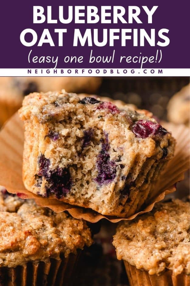 Blueberry oatmeal muffin with the wrapper off and a bite taken out of it.