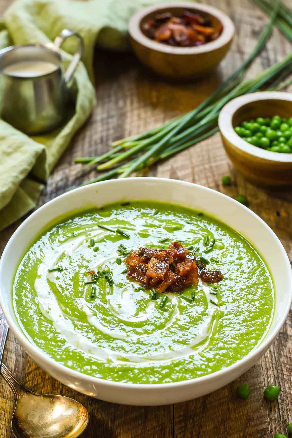 Green Pea Soup with smoky sweet candied bacon is a party for your tastebuds! Light, but creamy, sweet and salty, it's perfect for any spring meal!