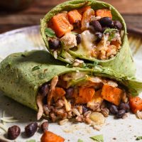 Sweet Potato Black Bean Burritos are loaded with protein, melty cheese, spicy black beans, and smoky maple sweet potatoes. The perfect freezer meal!