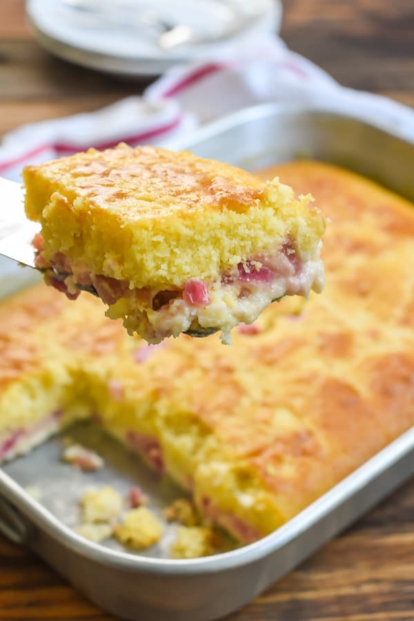 This Rhubarb Custard Cake has a fluffy cake layer and a creamy sweet rhubarb custard layer. It's beautiful, delicious, and SO EASY to make!