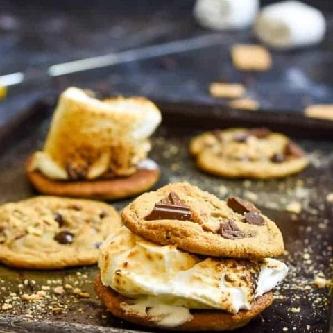 Graham Cracker Chocolate Chip Cookies sandwiched around a toasted marshmallow is all you need for a perfect camping dessert.