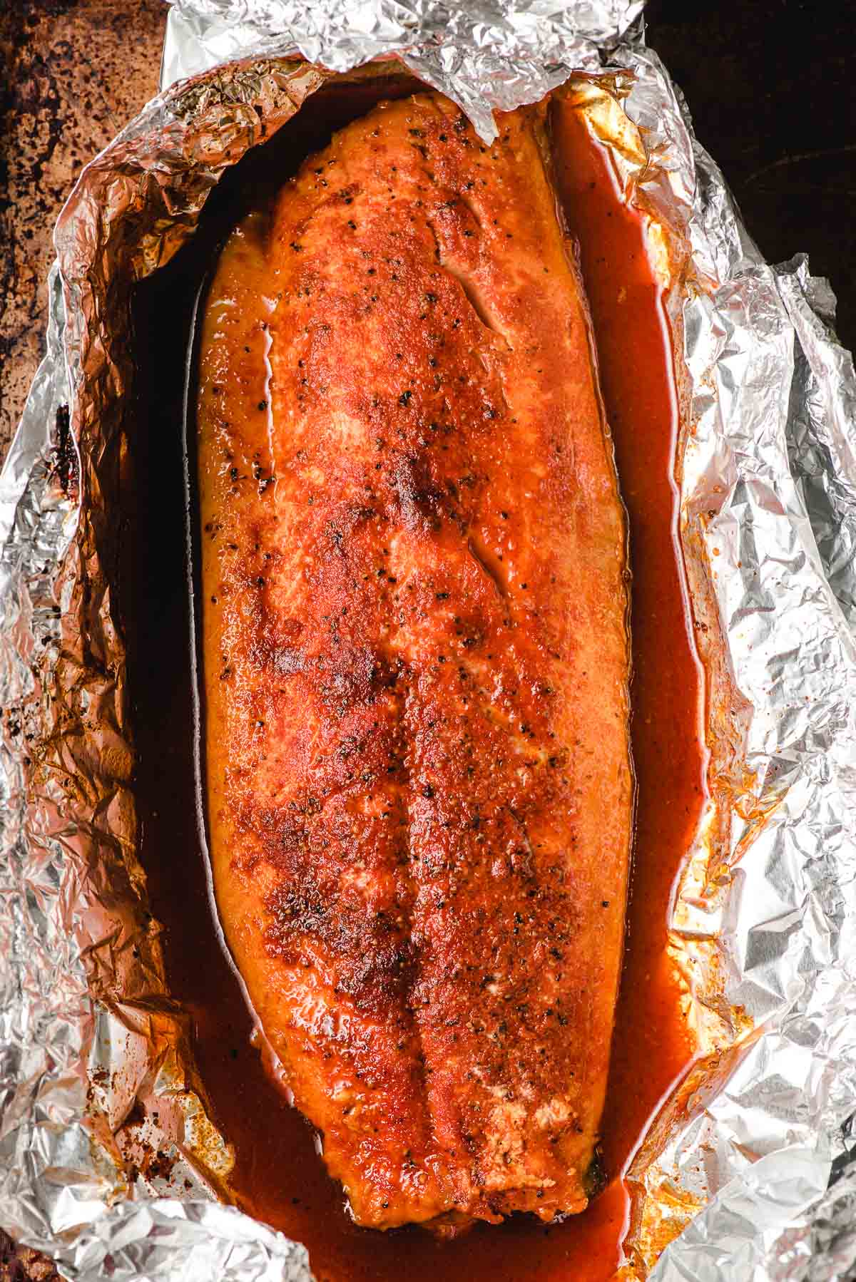 Grilled salmon seasoned with smoked paprika in foil.