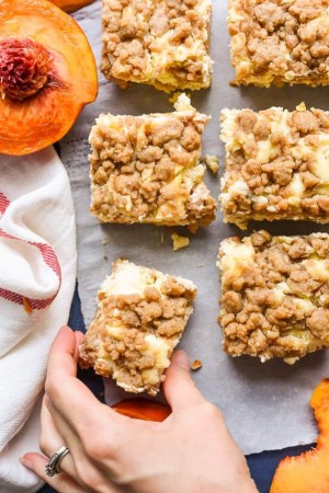 Peach Cobbler Cheesecake Bars combine two of my favorite desserts for an awesome summer treat.