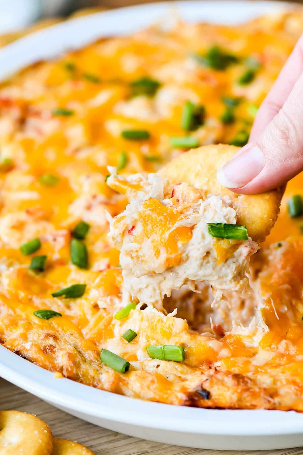 Cheesy crab dip on a Ritz cracker.