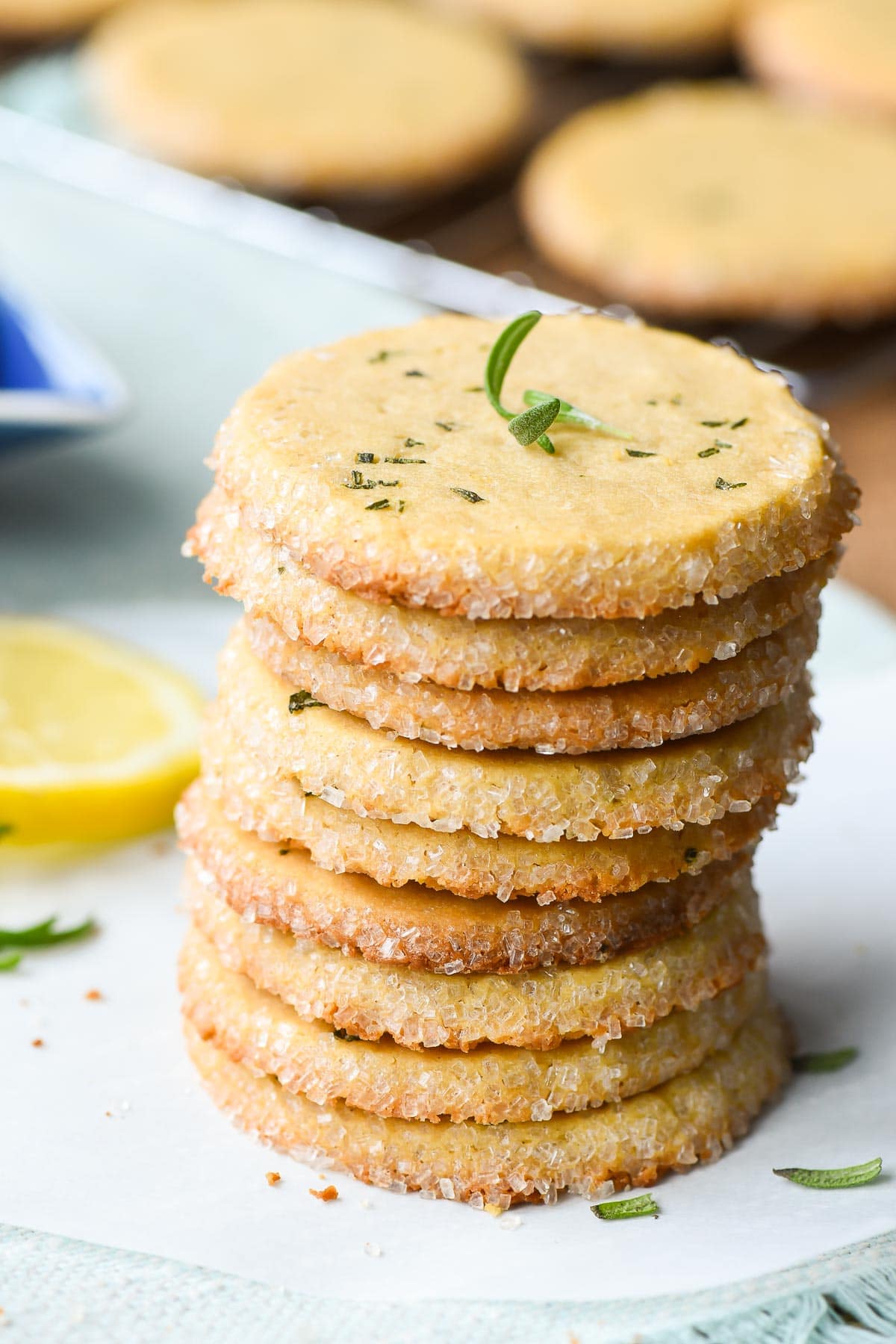 Stack of lemon butter cookies with rosemary on top