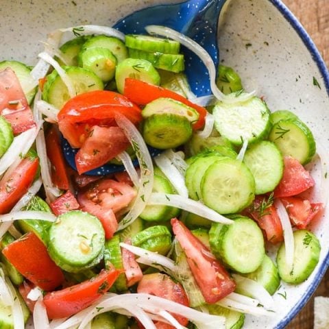 Colorful cucumber and tomato salad with dill