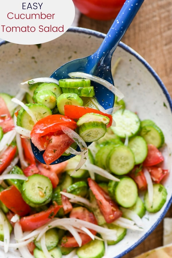 Cucumbers, Tomatoes, and Onions tossed with a vinaigrette in a bowl