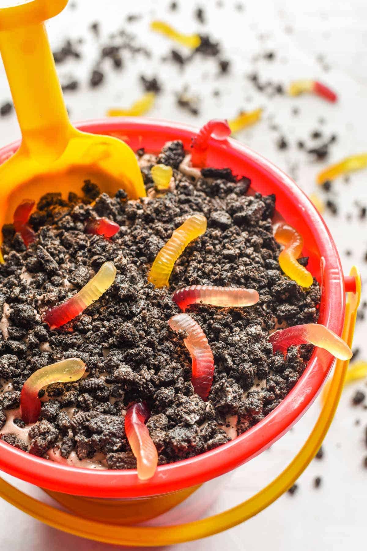 Dirt and Worms an Earth Day dessert! Required ingredients are the mud  (chocolate pudding), topsoil (crushed Oreos), and worms (gummy worms).  Additional ingredients for flair are chocolate rocks and fresh mint leaves.  