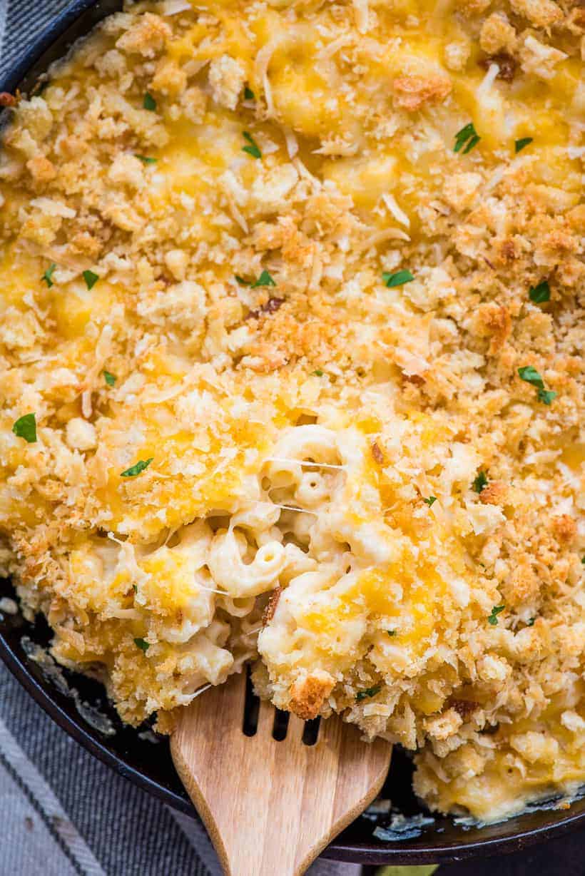 Creamy Baked Mac and Cheese with a wooden spoon