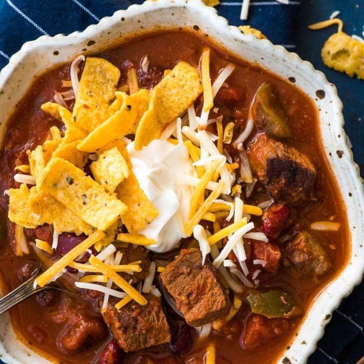 Slow Cooker Steak Chili with cheese, sour cream, and fritos