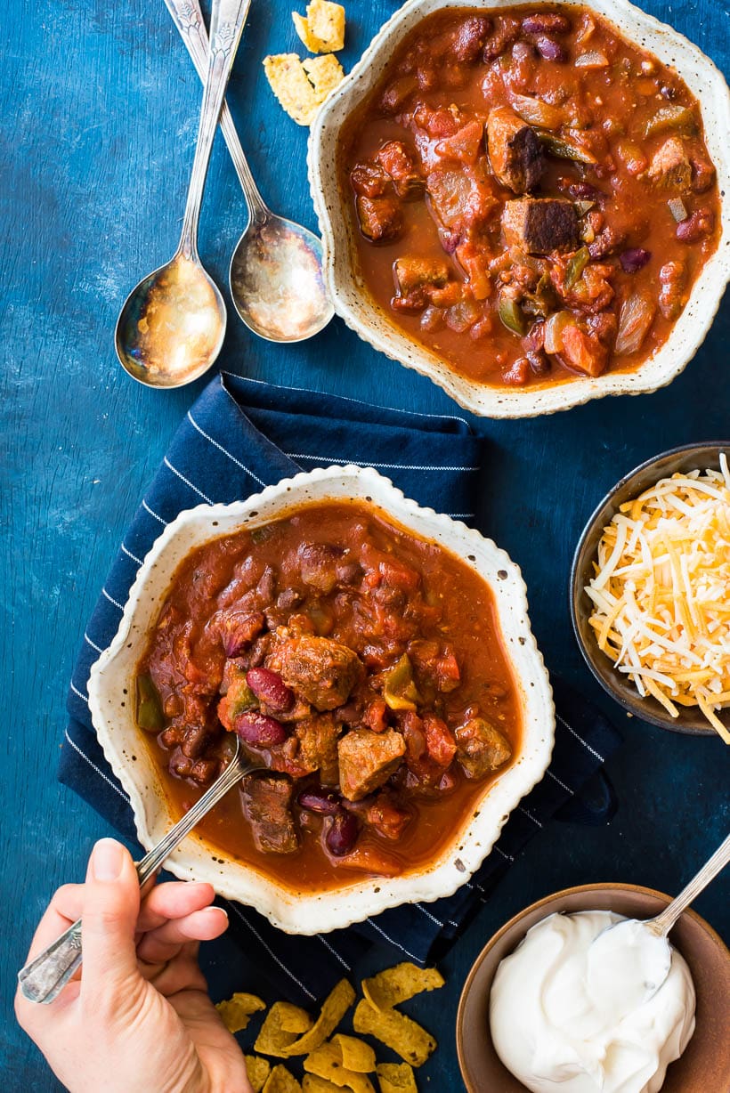 Slow Cooker Steak Chili in bowls with spoons