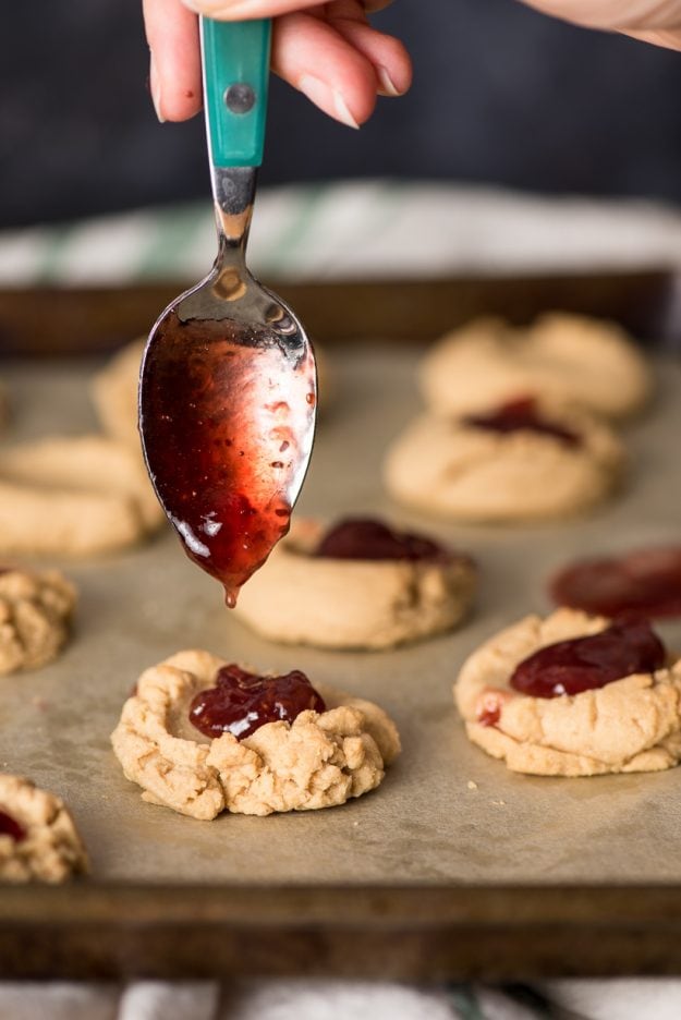 Peanut Butter Thumbprint cookies with a spoonful of raspberry jam