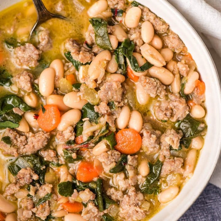Italian sausage stew with white beans and chard in a bowl