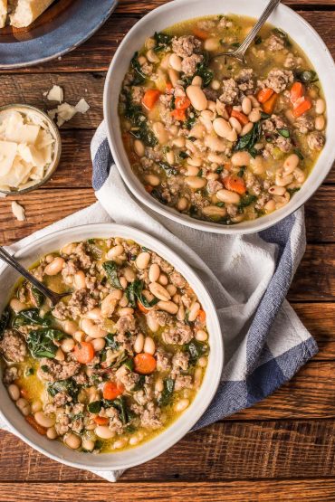 two bowls of Italian Sausage Stew with greens and white beans