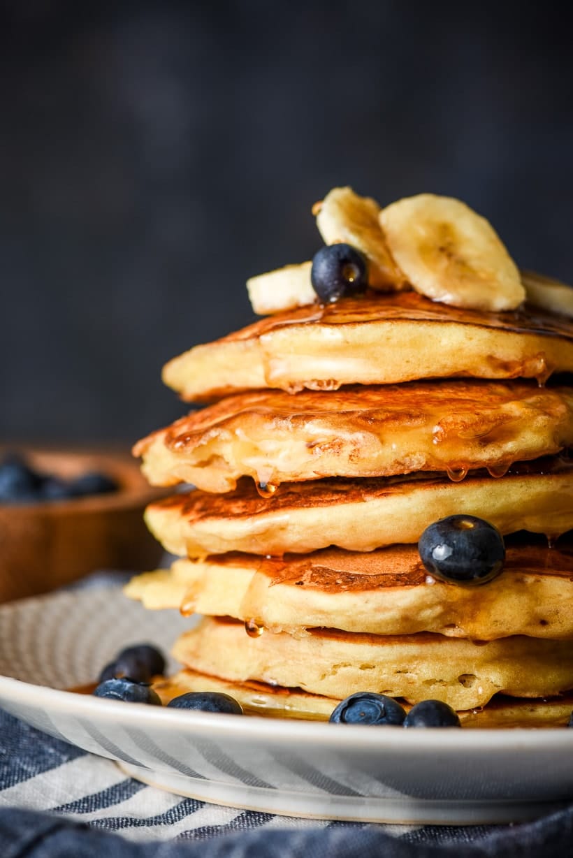 stack of ricotta pancakes with blueberries and bananas