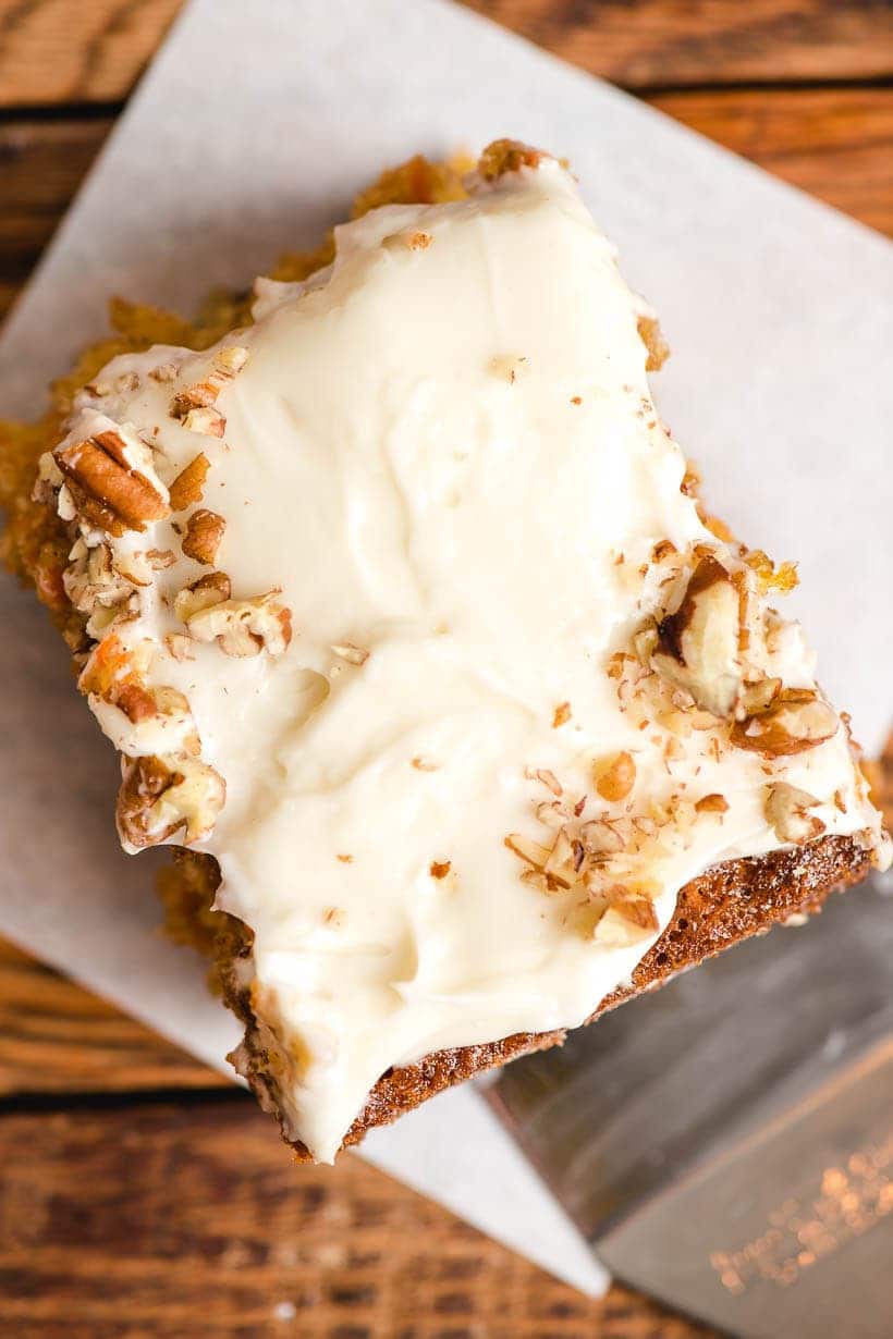 Slice of carrot sheet cake with cream cheese frosting