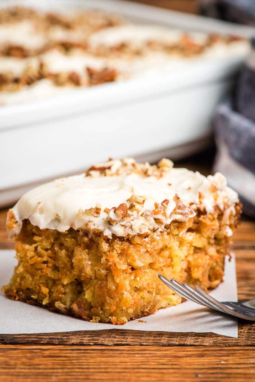Carrot Sheet Cake slice with cream cheese frosting and pecans
