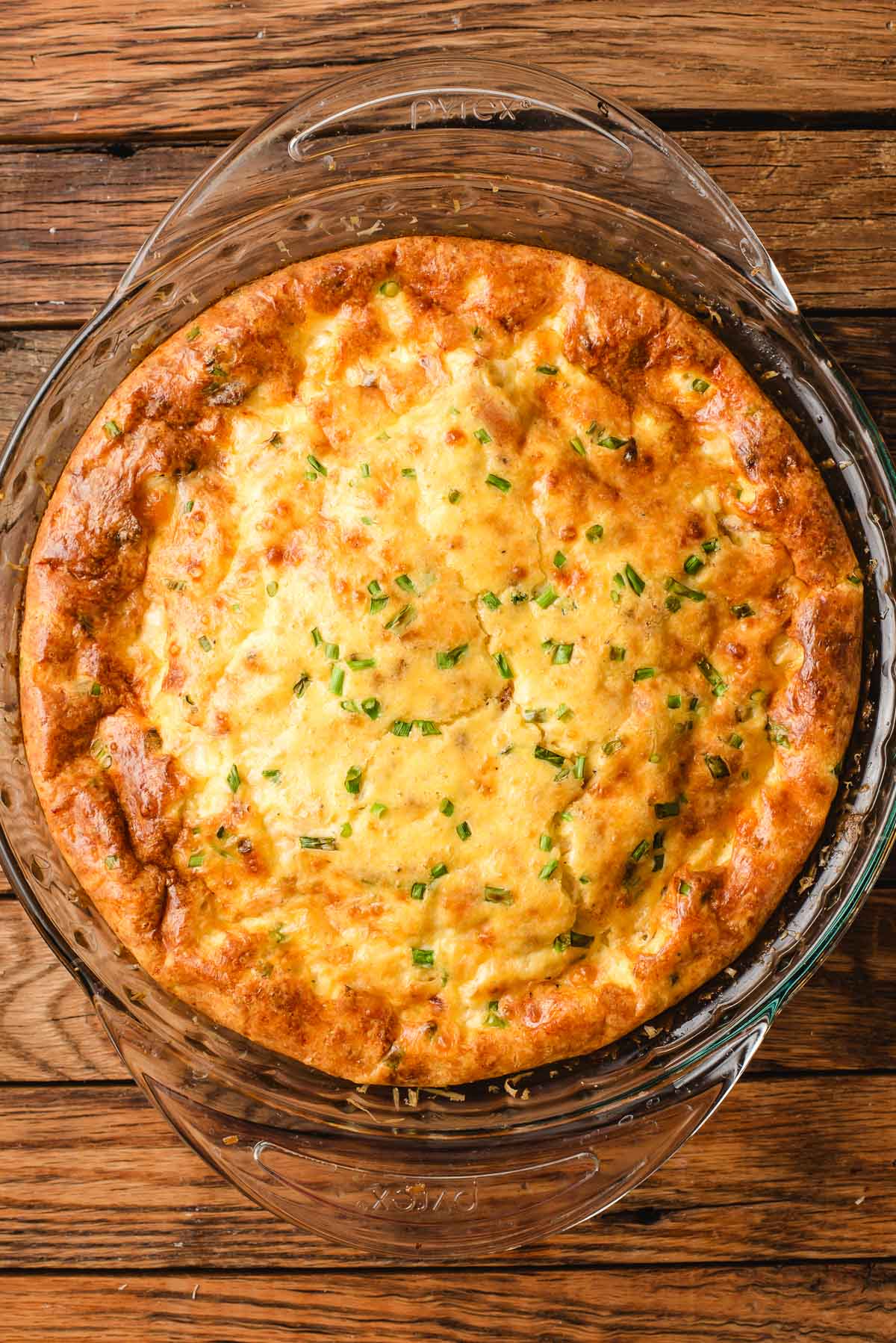 Crustless quiche in a glass pie pan.
