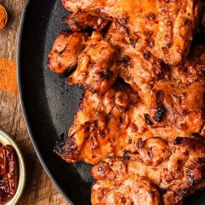 Spicy Grilled Chicken Thighs on a cast iron platter.