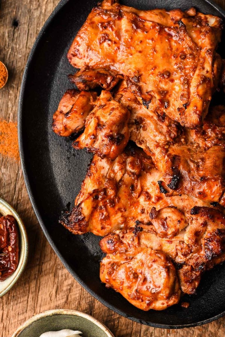 Spicy Grilled Chicken Thighs on a cast iron platter.
