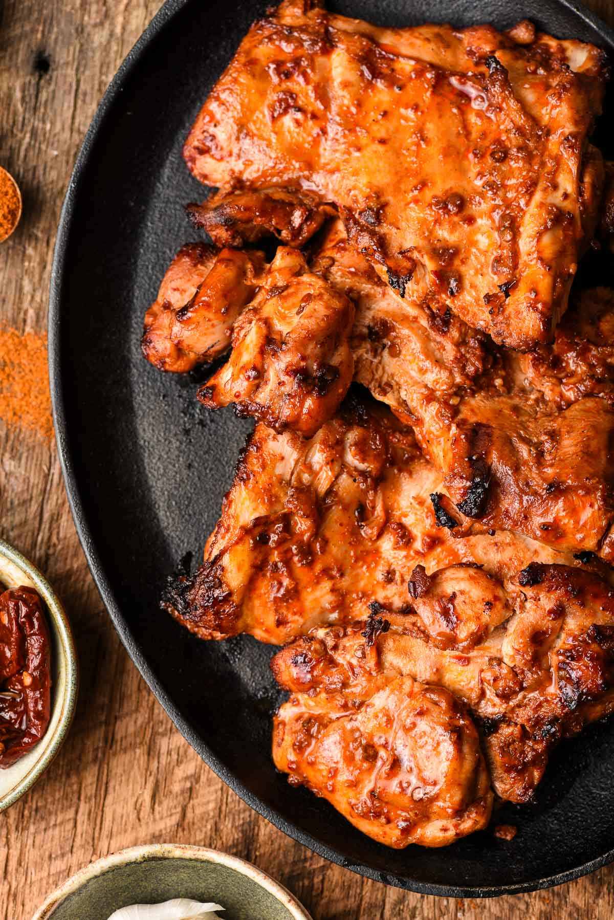Spicy Grilled Chicken Thighs on a cast iron platter.
