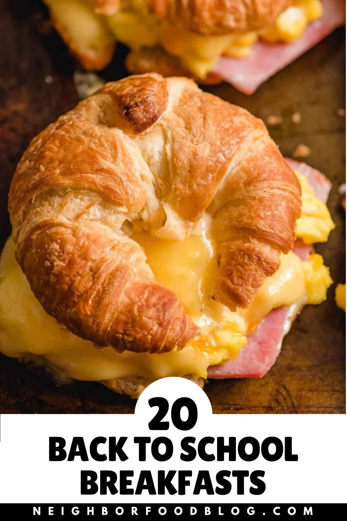 A croissant, egg, and cheese sandwich and a slice of lemon blueberry bread.