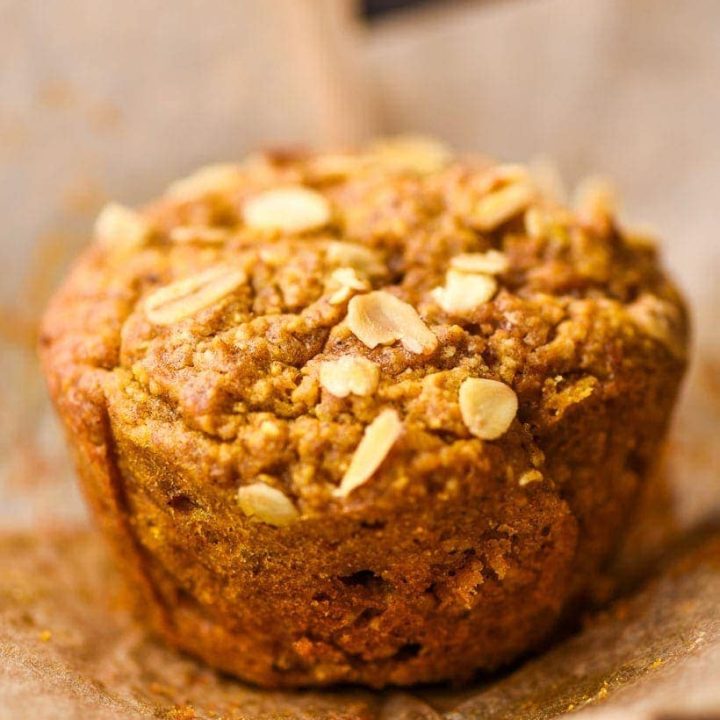 single pumpkin oatmeal muffin with a paper wrapper around it