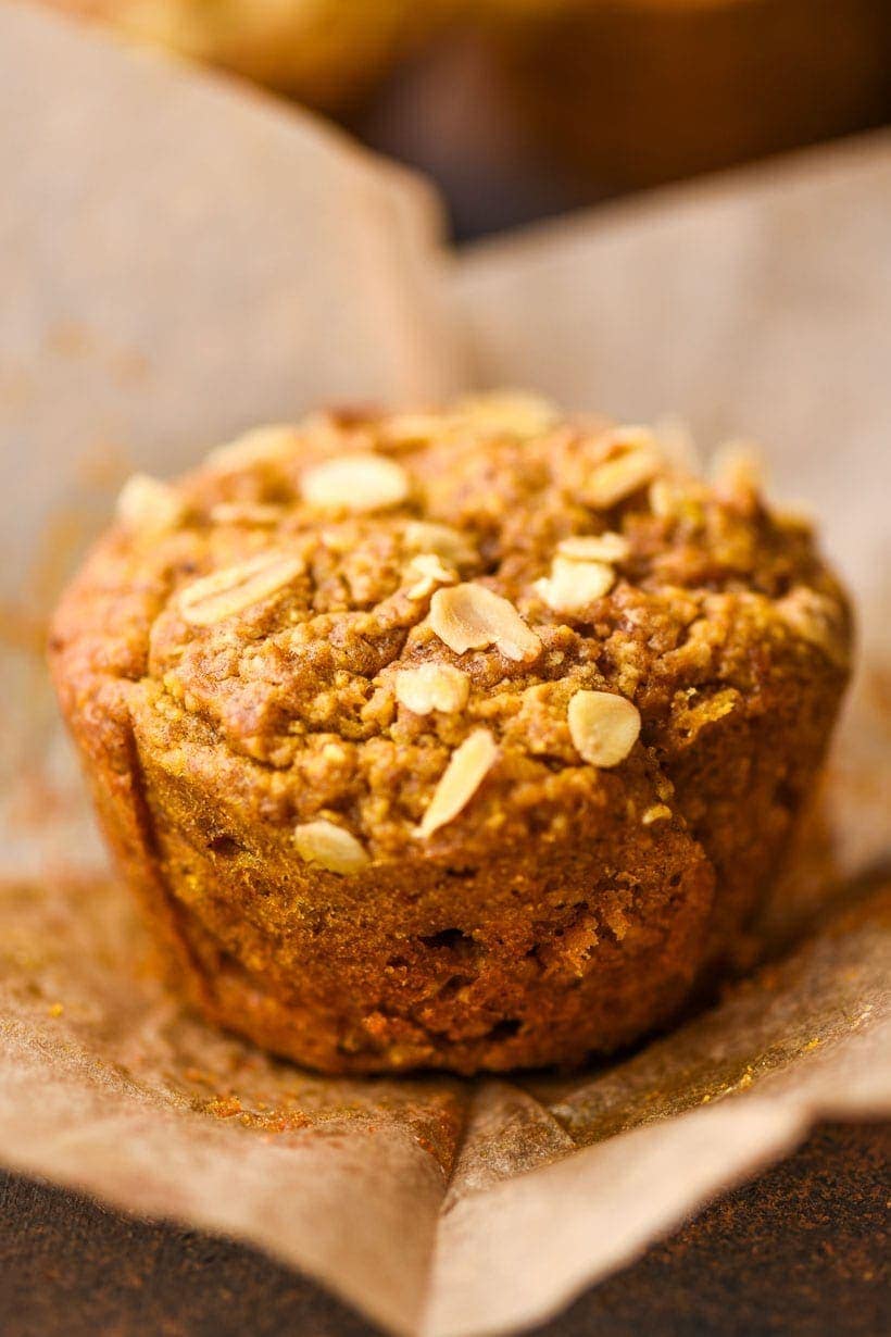 single pumpkin oatmeal muffin with a paper wrapper around it