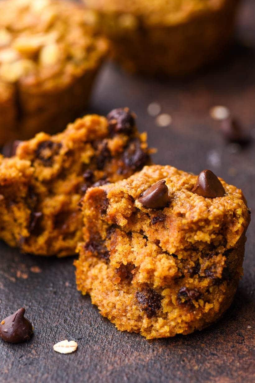 healthy pumpkin muffin split open to reveal chocolate chips