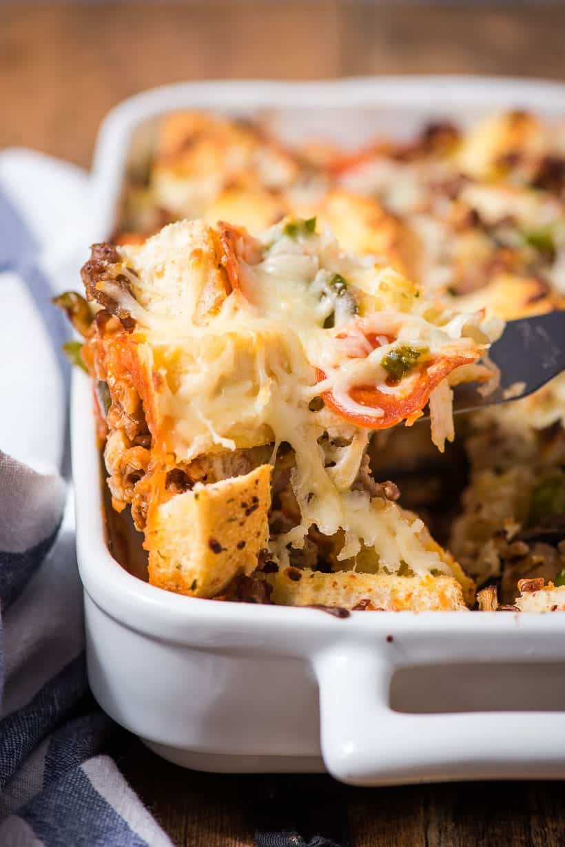 spatula lifting a slice of pizza casserole out of a pan