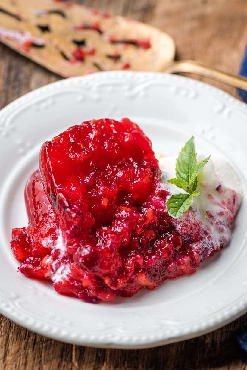 Slice of Cranberry Jello Salad with Whipped Cream
