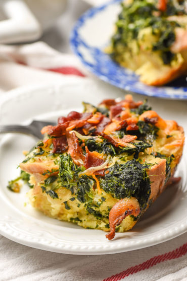 slice of breakfast casserole with bacon on a white plate