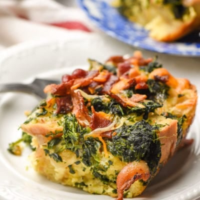 slice of breakfast casserole with bacon on a white plate