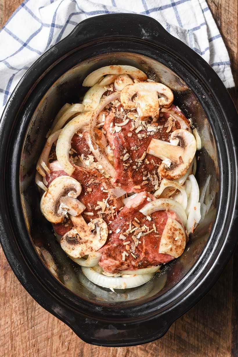 round fillets in a clay pot with mushrooms and onions