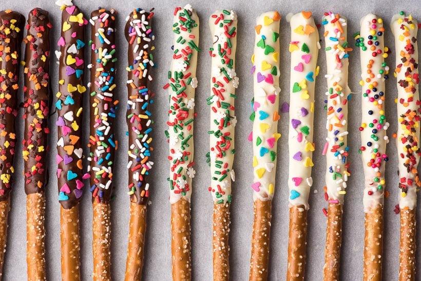 white and dark chocolate covered pretzel rods in a row