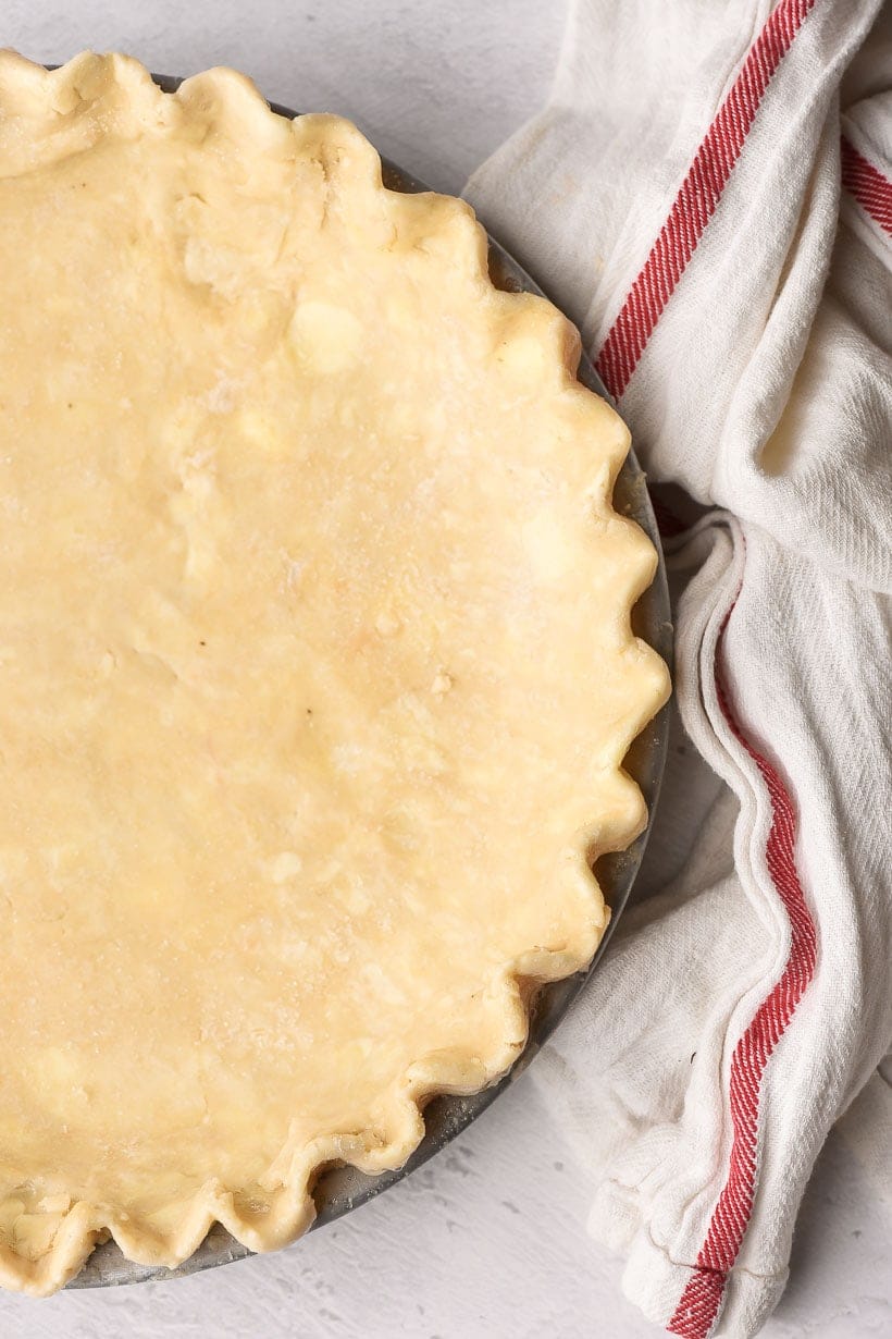 homemade pie crust crimped in the pie pan