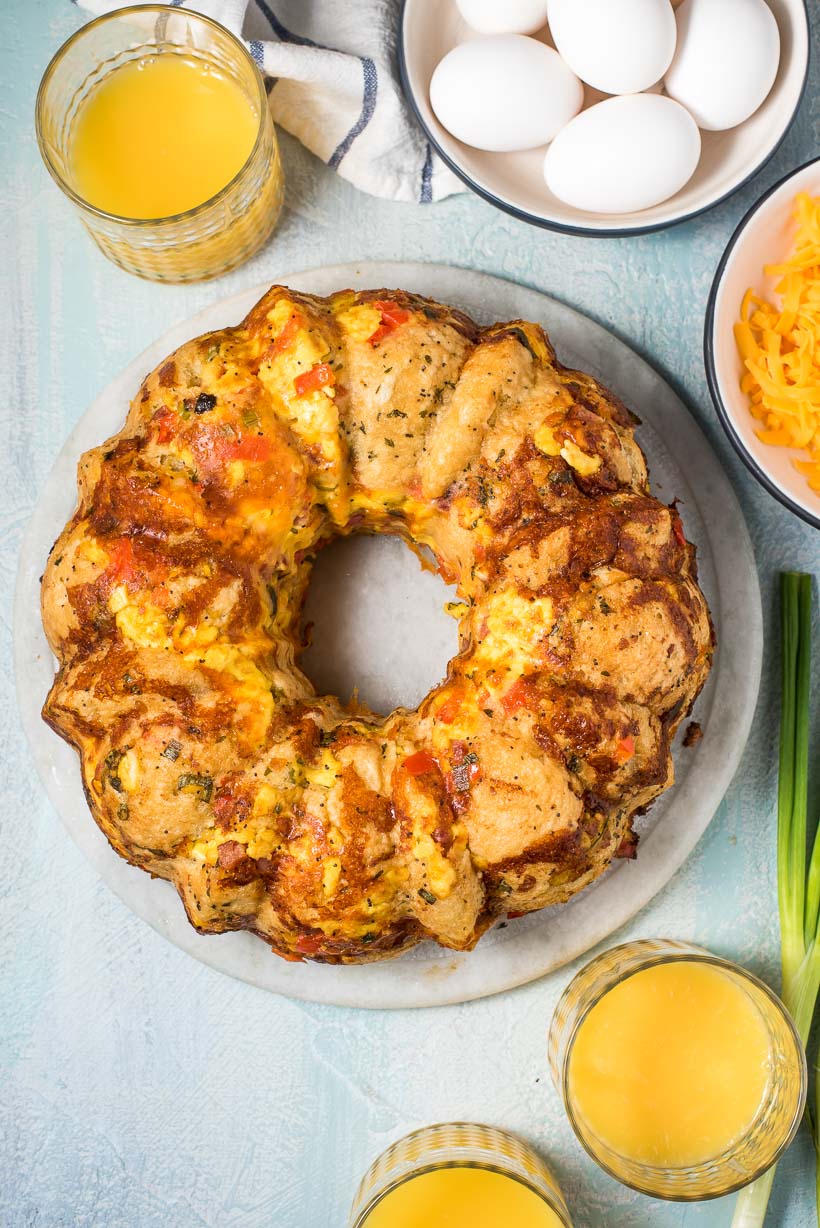 Breakfast Pull Apart Bread on a marble platter with orange juice glasses nearby