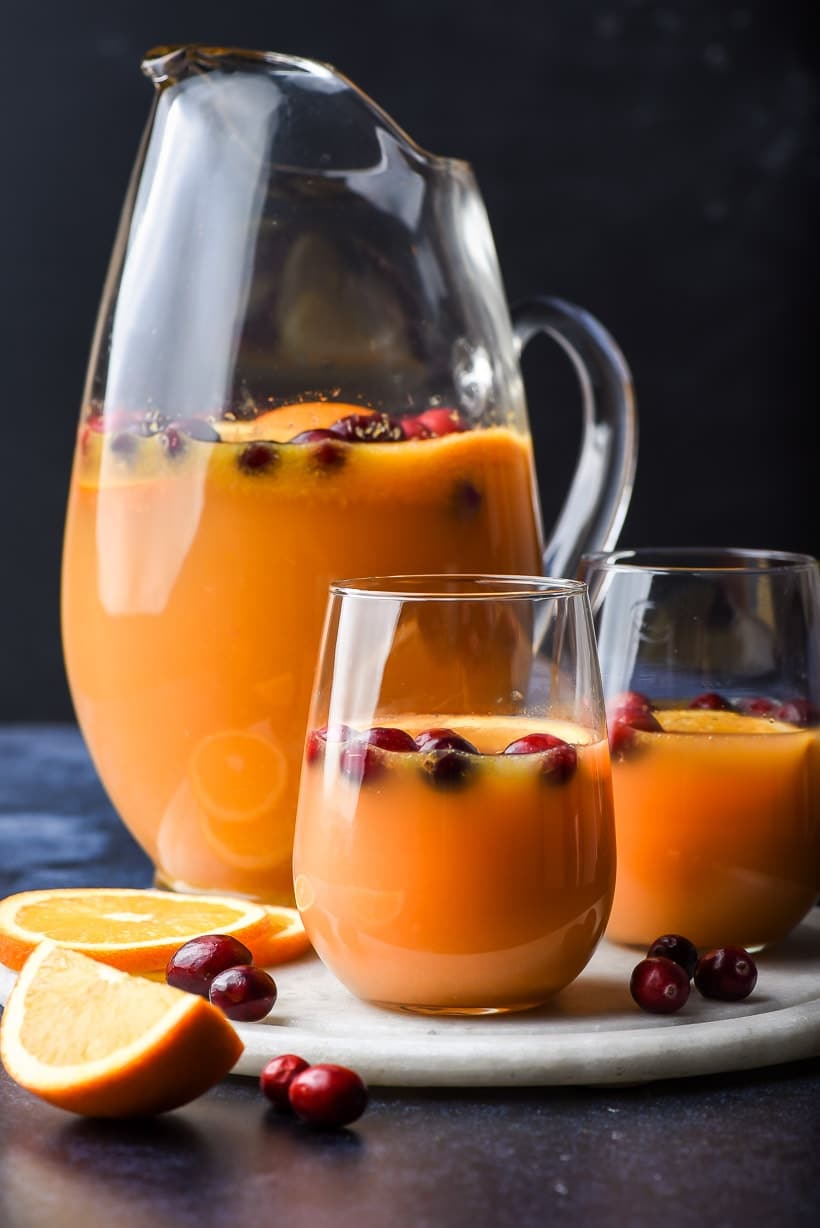 Pitcher of Christmas Morning Punch with two glasses of punch in front