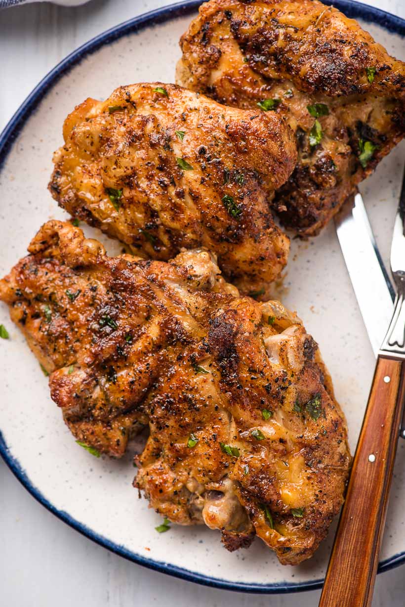 air fryer chicken thighs lined on a plate