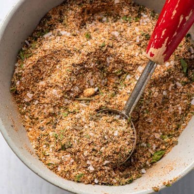 Chicken seasoning blend in a bowl with an old measuring spoon.