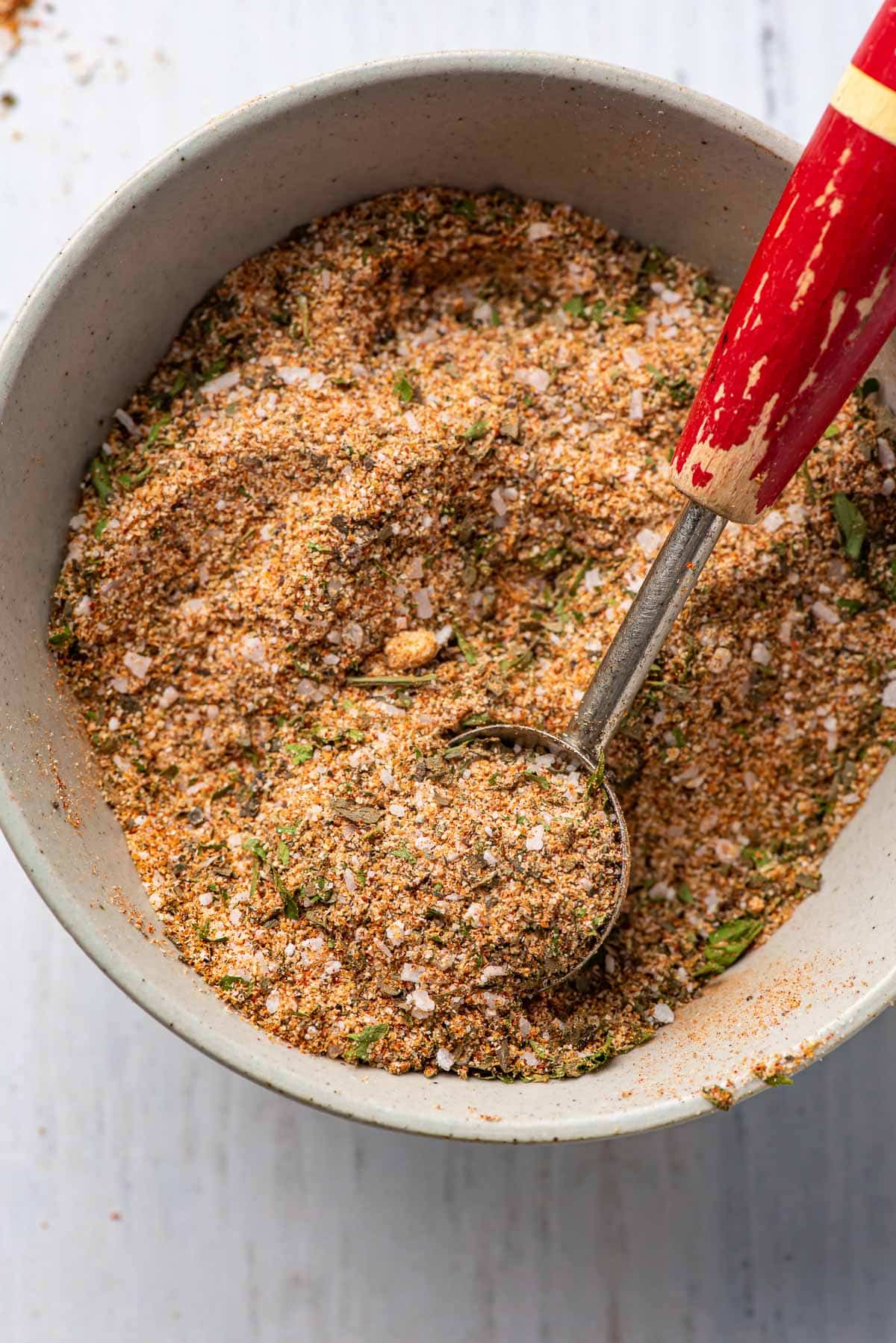 Chicken seasoning blend in a bowl with an old measuring spoon.