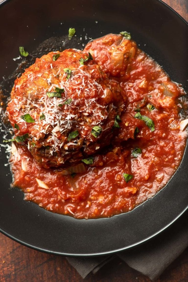 giant meatball with parmesan and basil garnish