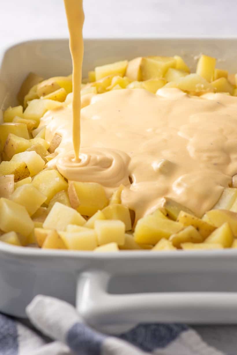 homemade cheese sauce poured over potatoes