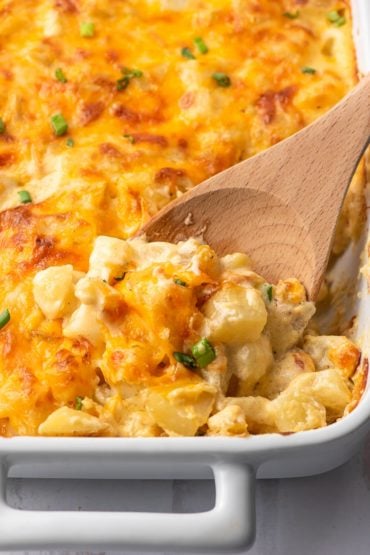 wooden spoon scooping cheesy potatoes