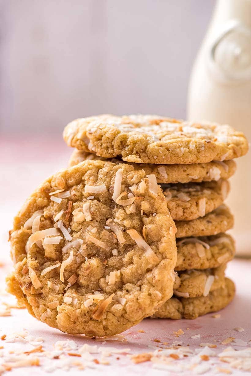 stack of coconut cookies with one cookie propped in front