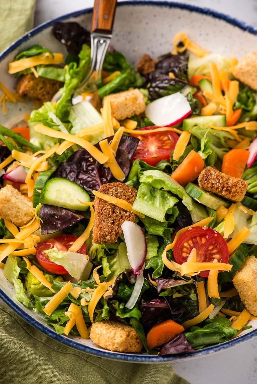 bowl of salad with croutons and cheese