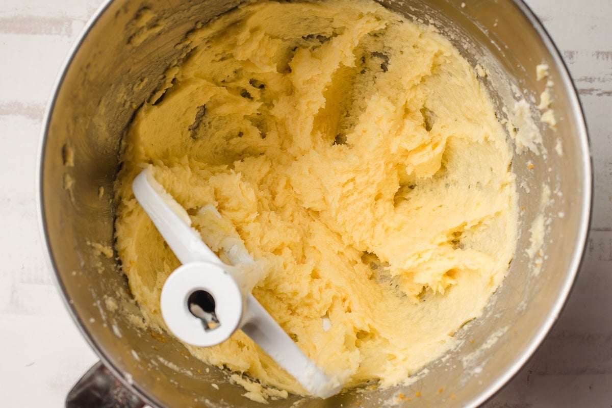 Butter, sugars, and orange zest beaten together in a mixing bowl.