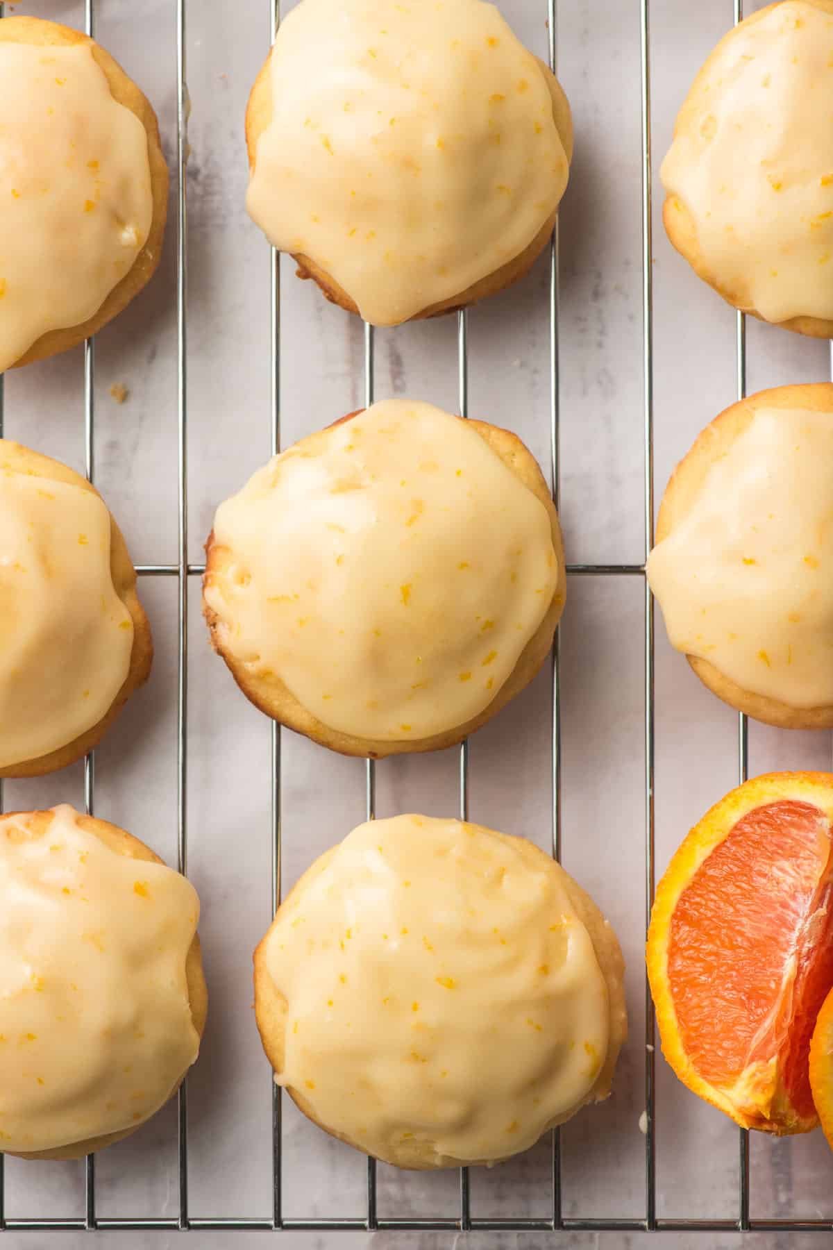 Iced orange cookies on a cooling rack.